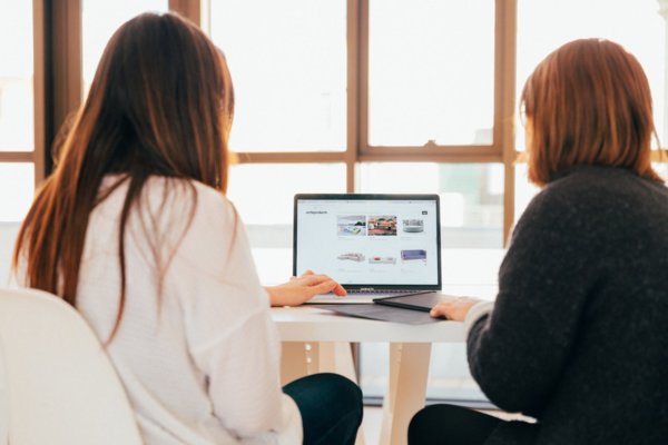 2 people at a laptop