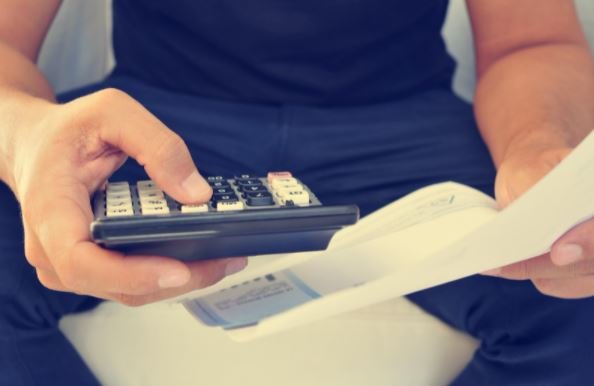 man holding calculator