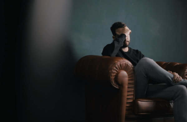 man upset on sofa