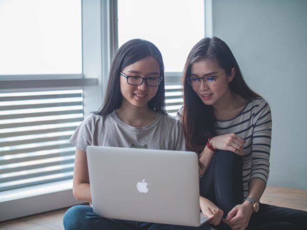 two people on a laptop
