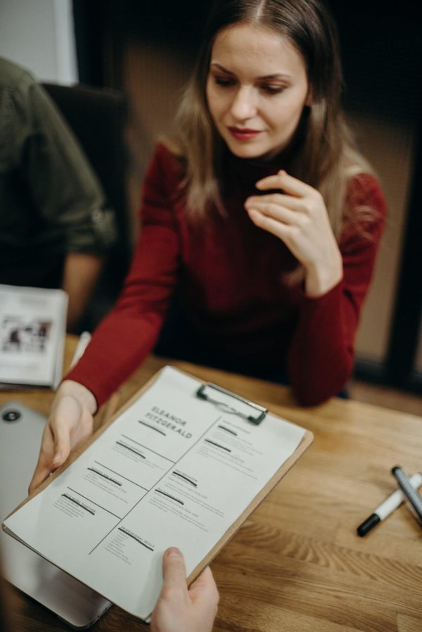 woman grabbing a clipboard  