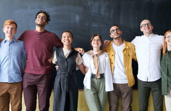 Satisfied Employees Standing Together in a Group