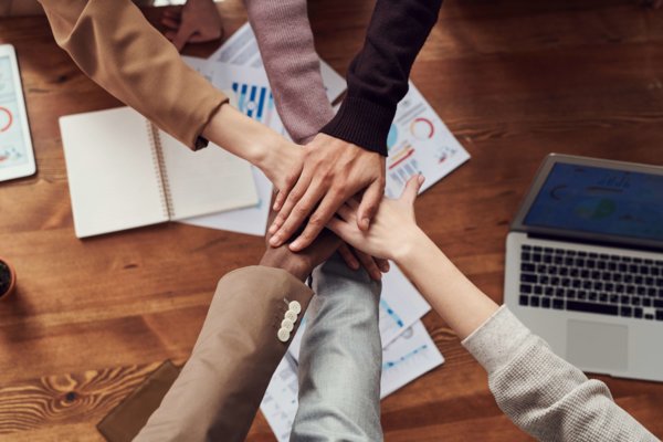 Employees Holding Each Others Hands