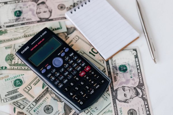 calculator money and paper pad