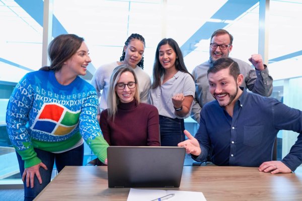 people around a laptop