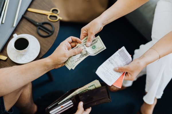 A Person Giving Money To Someone