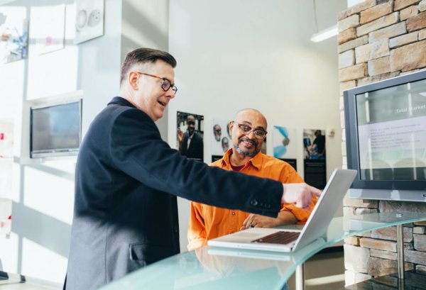 man pointing at laptop