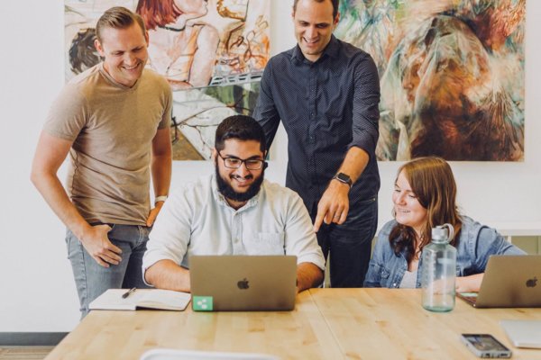 people around a laptop