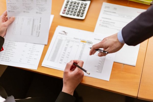 person pointing to paper
